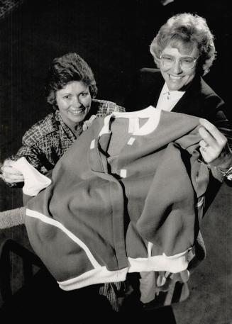 Suitable: Registered nurses Angela Platt, left, and Paula Smith show a green and white fleece track suit they designed for physically disabled people