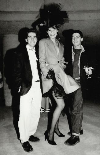 Above, twin Ports International designers Dean, right, and Dan Caten flank model Susan Willemsen in a Ports design buoyed by a flirtatious crinoline