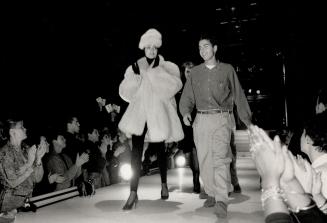 Luxurious fur: Left, Dean Caten, who designs with identical twin brother Dan, with model in pink fox fur coat, $6,000, matching hat