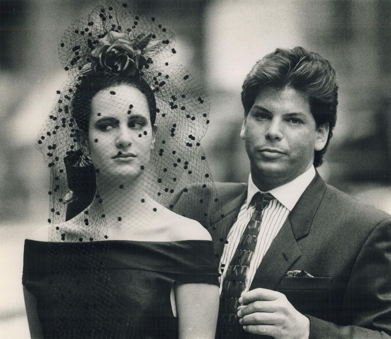 Veiled allure: Hat designer Kokin poses with model wearing April in Paris, his study in elegance in yards of hand-made netting and black silk roses, $198 at The Irish Shop