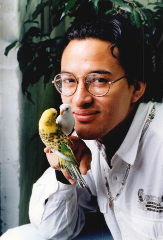 Above, D'Acry Moses, a member of the Gitksan west coast Indian nation, with parakeets Pablo and Wallis