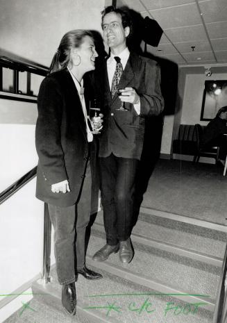 Left, Hoax Couture designer Jim Searle in a multi-bright Eastern motif tie, with friend Sarah MacLacklan