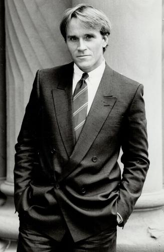Lee Wright: New York designer, above, wears one of his own black silk double-breasted suits with a cotton shirt and boldly striped tie
