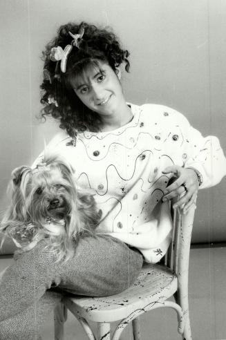 Splash-crazy: Sharon Attias, 20, with her Yorkshire terrier Chariot, models one of her creations ? a wave motif sweatshirt, $60