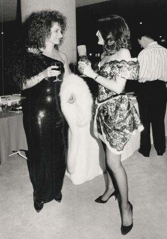 Far left, Rose Carinci, in a black and fox stole, with designer Isabella Briatico in a pearl-adorned dress
