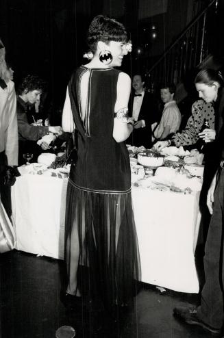 Below, designer Martine Ashfield wears Batman earrings with her own design, a black tunic dress