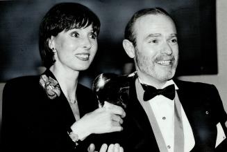 Two winners, Montreal designers Leo Chevalier and Dita Martin, toast their victory at the Clairol fashion award ceremony