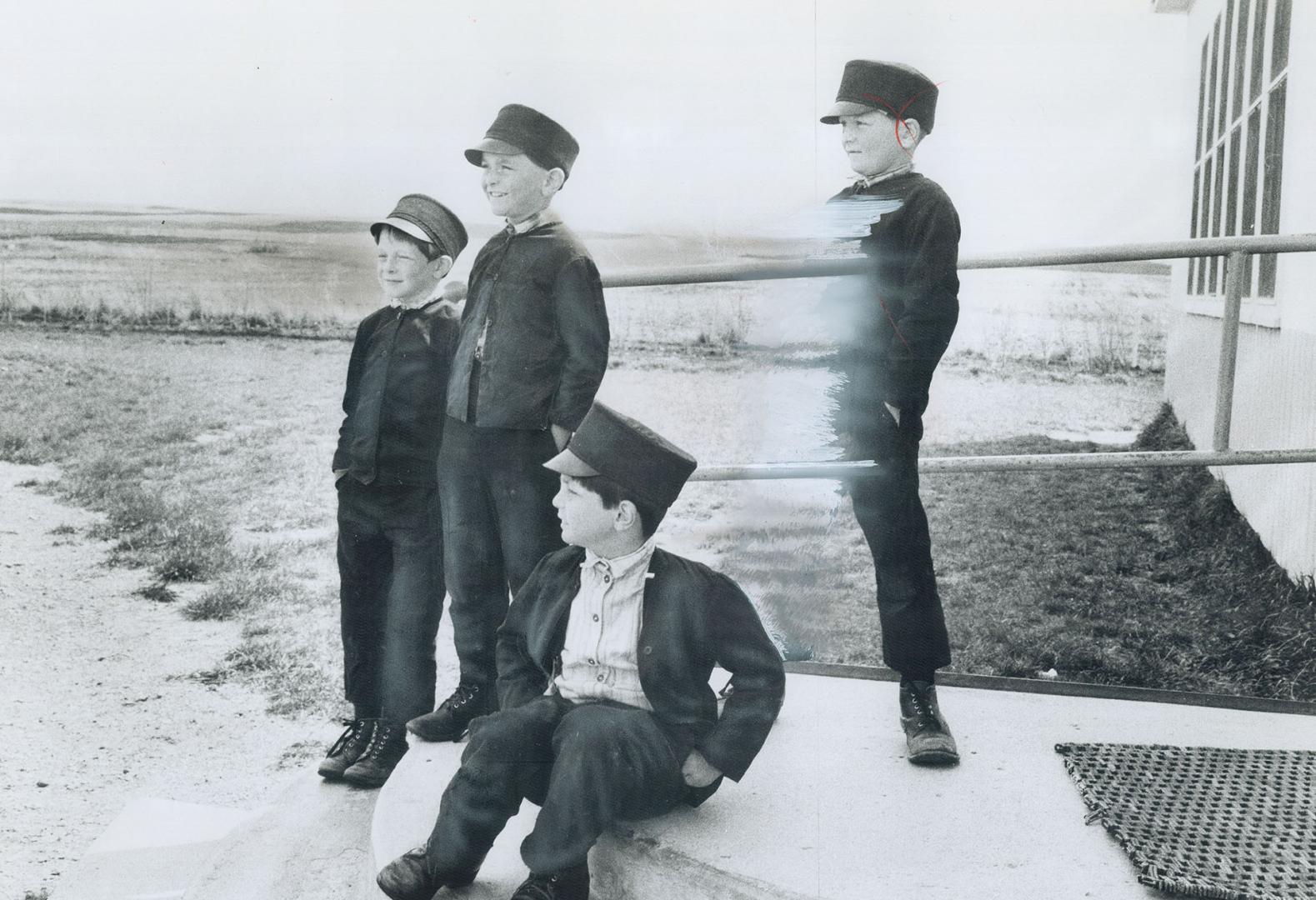Hutterite Boys wear peaked caps until leaving school at age 14 or 15