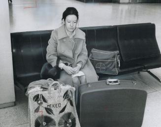 A long, lonely wait, Her dream of a new life shattered, Anna Maria DeGandler sits on a bench at Toronto International Airport, waiting for a baggage h(...)