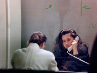 Behind bars: Two unidentified Soviet dancers speak to visitors from glass booths in lockup rooms after their arrest over stripping in a Concord tavern