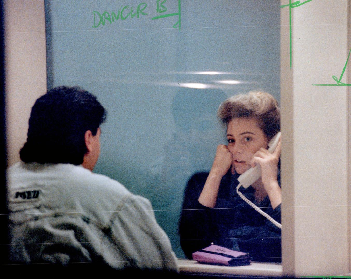 Behind bars: Two unidentified Soviet dancers speak to visitors from glass booths in lockup rooms after their arrest over stripping in a Concord tavern