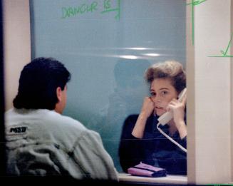 Behind bars: Two unidentified Soviet dancers speak to visitors from glass booths in lockup rooms after their arrest over stripping in a Concord tavern