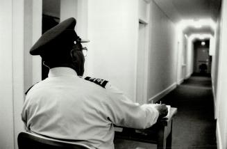 On duty: A security officer guards a corridor leading to detainee's rooms in a downtown detention centre