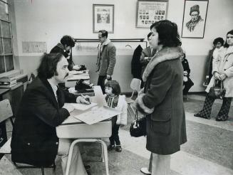 At Portuguese Information centre, an immigrant who can't speak English fluently is counselled