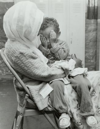 Almost there: A Somali mother and child wait in Buffalo church basement for a chance to enter Canada