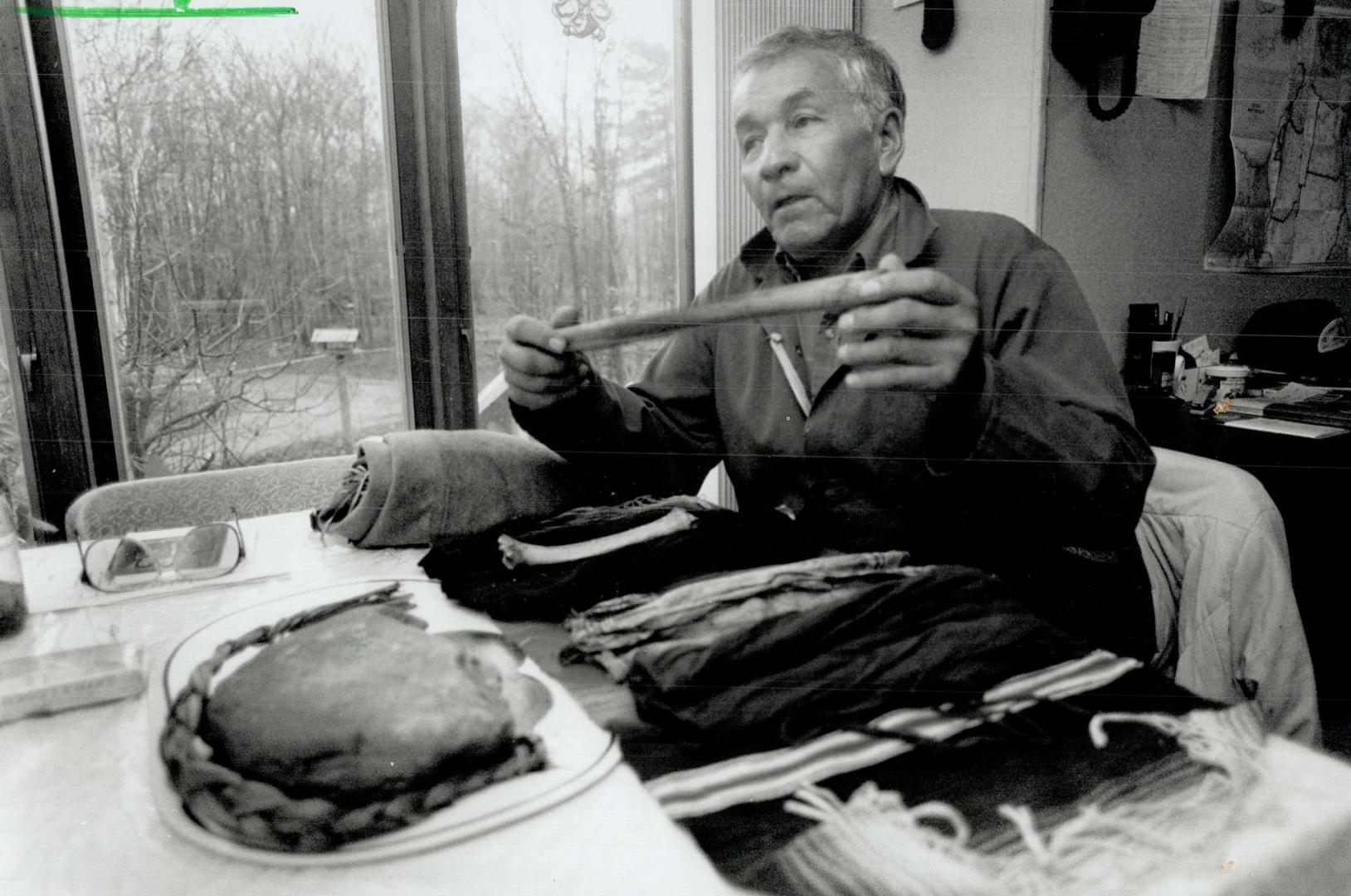 Keeper of the pipes: Farmer Martin Assinewe, 65, took the sacred native pipes to a church service marking the first anniversary of the ordination of the first Ojibwa priest