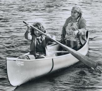 Grandmother Marie Williamson, 70, paddles off on a fishing expedition with her 7-year-old grand-daughter, Christine