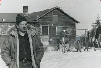 Jim Sinclair, a field worker for the Saskatchewan Metis Society, stands in front of a Metis shack in Meadow Lake, where there is no running water and (...)