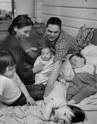 Among the Lucky, David Aglukark, 23, and his wife Dorothy, 21, hold Susan Christina, 4 months old, and play with Nancy (left), 4, and Barbara Ann, 1, (...)