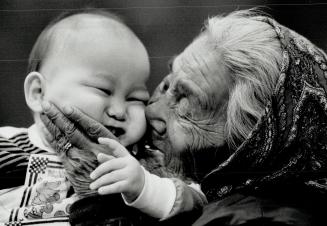 Apple of her eye: Jeannie Minaweetaituk, a 72-year-old Inuit great-grandmother, kisses her 1-year-old grandson, Harry Kudiu, in Kuujjuarapik, Que