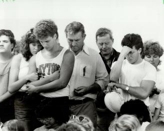 A group of Jehovah's Witnesses take part in their first prayer service in their freshly-completed auditorium