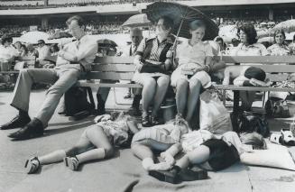 Relaxing in the sun, Jehovah's Witnesses listen to addresses at their four-day assembly at Woodbine racetrack, which opened yesterday. While three chi(...)