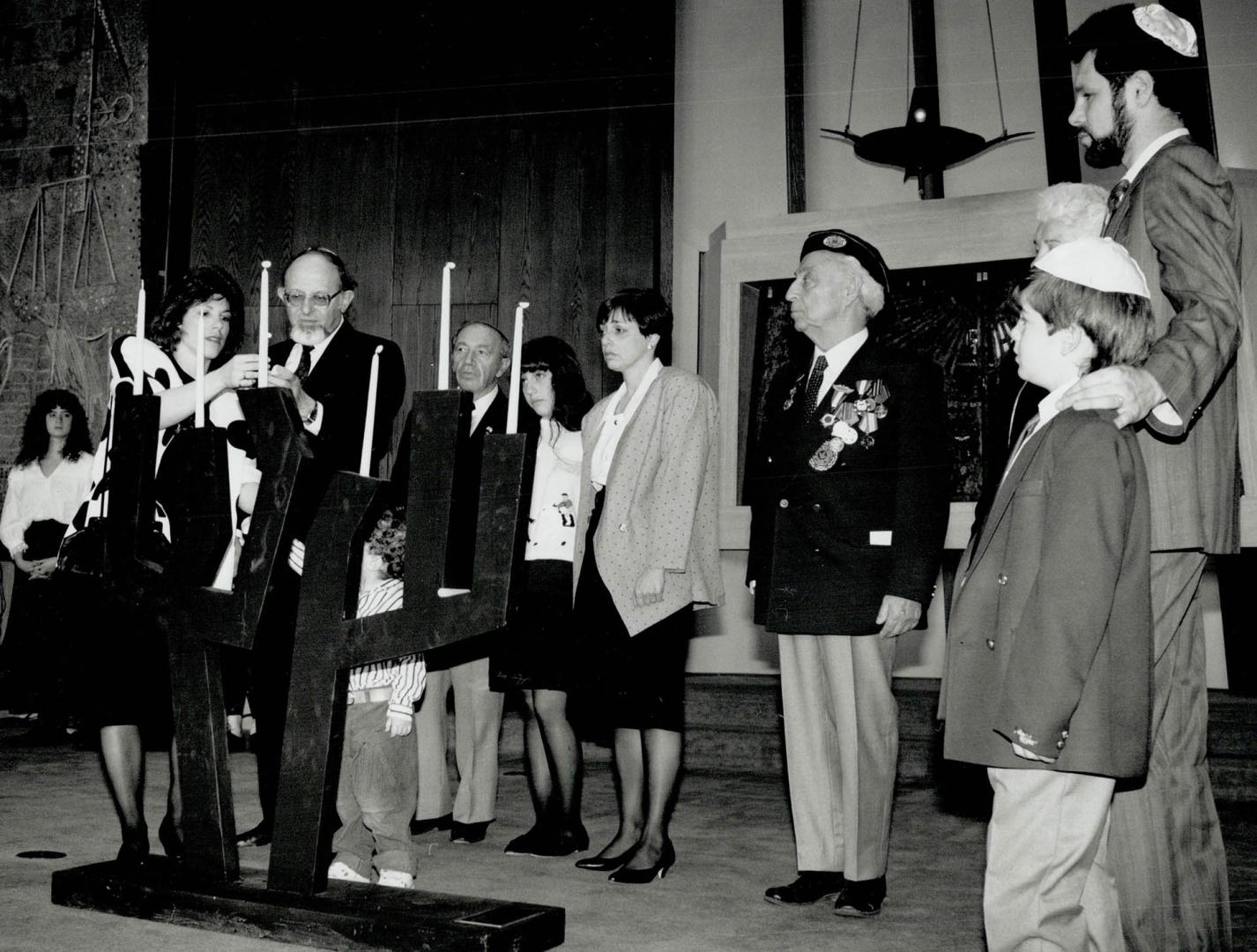 Solemn service: Veterans and families light candles yesterday at the Adath Israel Congregation synagogue to commemorate the 6 million Jews killed in the Holocaust