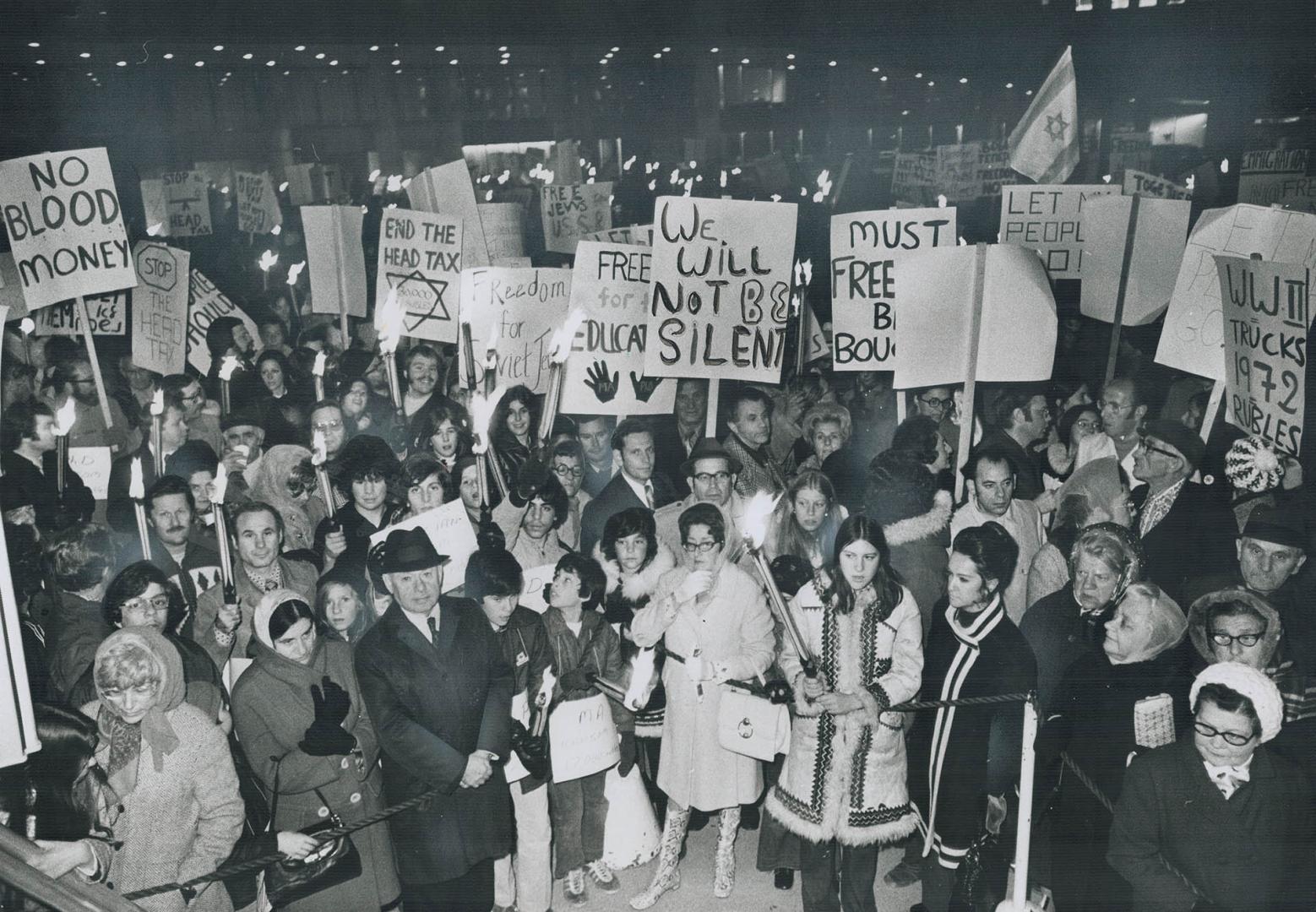 Signs and Torches raised high, more than 600 Jews rally in Nathan Phillips Square last night after a torchlight parade from Queen's Park urging that t(...)