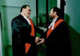 Judicial Choices, Harvey Salem, left, and David Cole congratulate each other after they were sworn in as provincial judges yesterday at old city hall.(...)