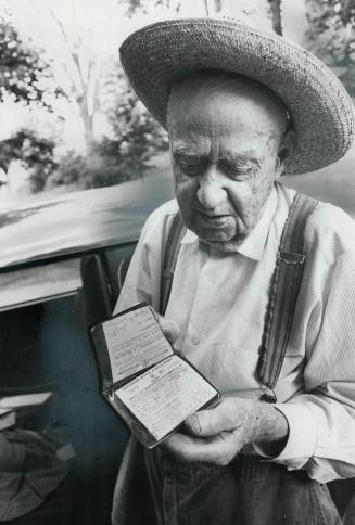 Harry Caton, 91, a 40-mph driver, shows his driving license