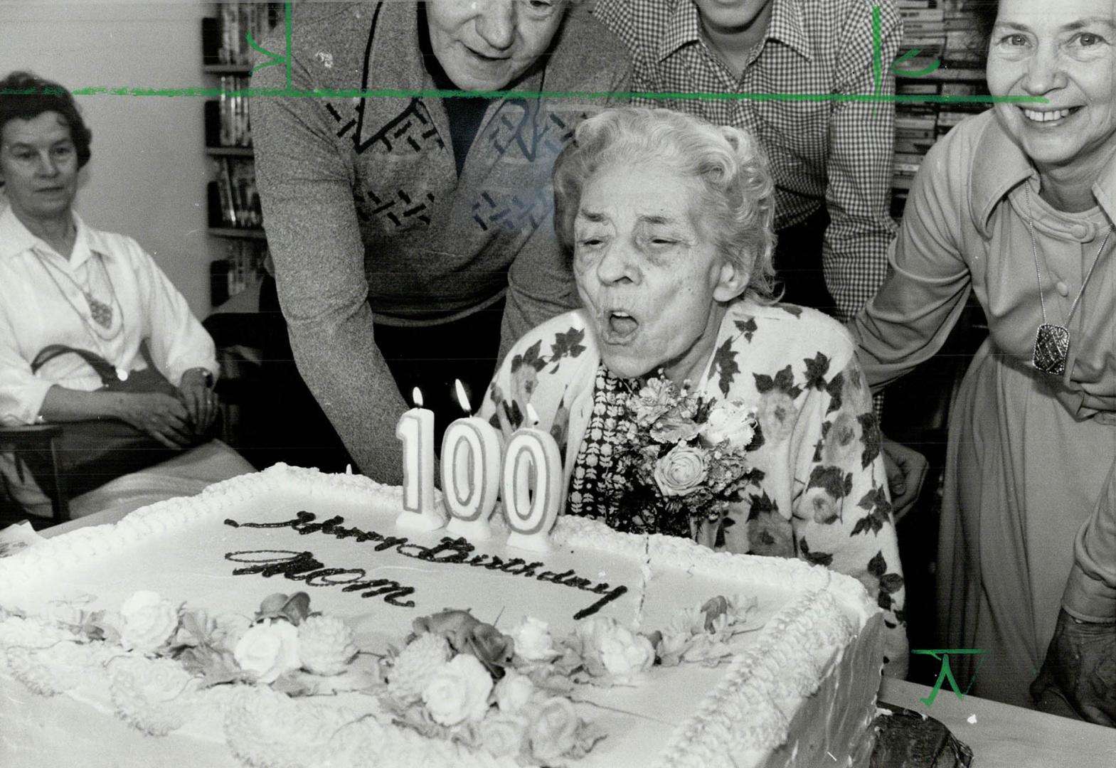 2nd century, Emma Louisa Lock, 100 years old today, blows out candles on her birthday cake at Cummer House home for the aged in North York at a party thrown for her yesterday by about 30 relatives