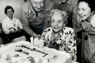 2nd century, Emma Louisa Lock, 100 years old today, blows out candles on her birthday cake at Cummer House home for the aged in North York at a party thrown for her yesterday by about 30 relatives