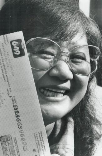 Happy new millionaire, Willowdale housewife Mo Wan Cheung, 50, smiles happily over the $2