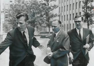 Ex-Magistrate David Coon, left, leaves courthouse on University Ave