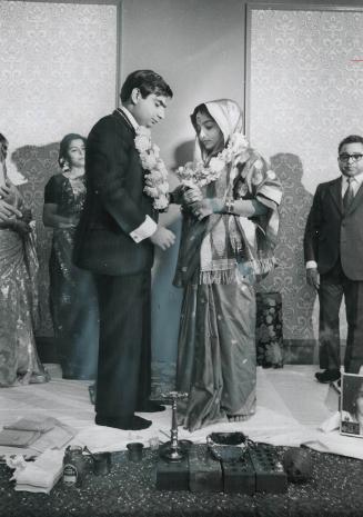 Hindu ritual observed, Rukmini Khera (right) and Ajay Burman take oath in front of fire, symbolizing eternity, during Hindu wedding ceremony held Saturday at Holiday Inn, Scarborough