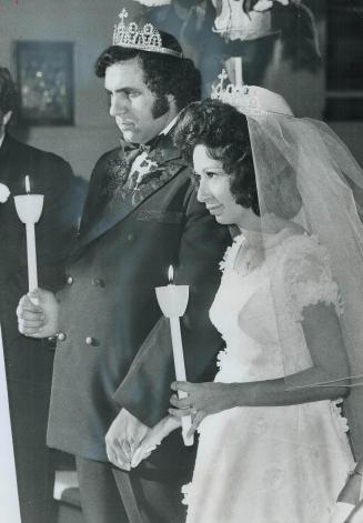 Looking solemn during their Greek Orthodox wedding Saturday are Nina-Maria Cira and Theodore Habib