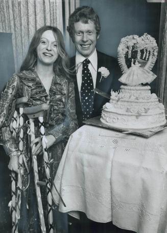 Crutches decorated for her wedding day, bride Eva Risling and her groom, Russell McNeil, admire the bridal cake after their wedding yesterday. Russell(...)