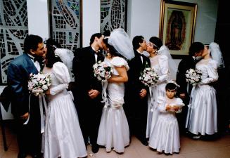 Brothers Marion, Gonzalo, Gaston and Darwin Nieto kiss their brides Angela Ximena, Mirian and Mercedes