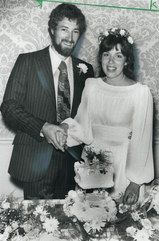 Rex Porter, 27, and his bride, Joanne Walker, 27, cut their wedding cake Saturday in the Westbury Hotel