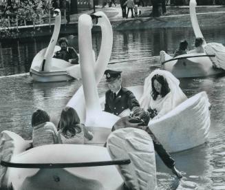 Wedding at Centre Island, Nineteen-year-old Mark Vyse of Camp Borden and his bride, Carmen Duscha, 18, ride a swan boat after their wedding Saturday i(...)