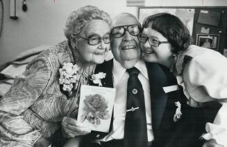 60 years together, Myrtle and Norman Hallett, both a young-looking 88, share their delight with grand-daughter, Tami, 15, as they celebrate their 60th(...)