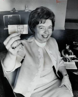Mrs. Anne Wright, Long Branch biscuit-packer, triumphantly holds Irish sweepstakes ticket that won her $30,000 and says delightedly Isn't it beautiful?