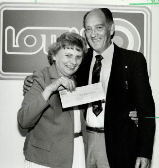 No surprise? Elizabeth Langille and her husband Morley hold their cheque for $1