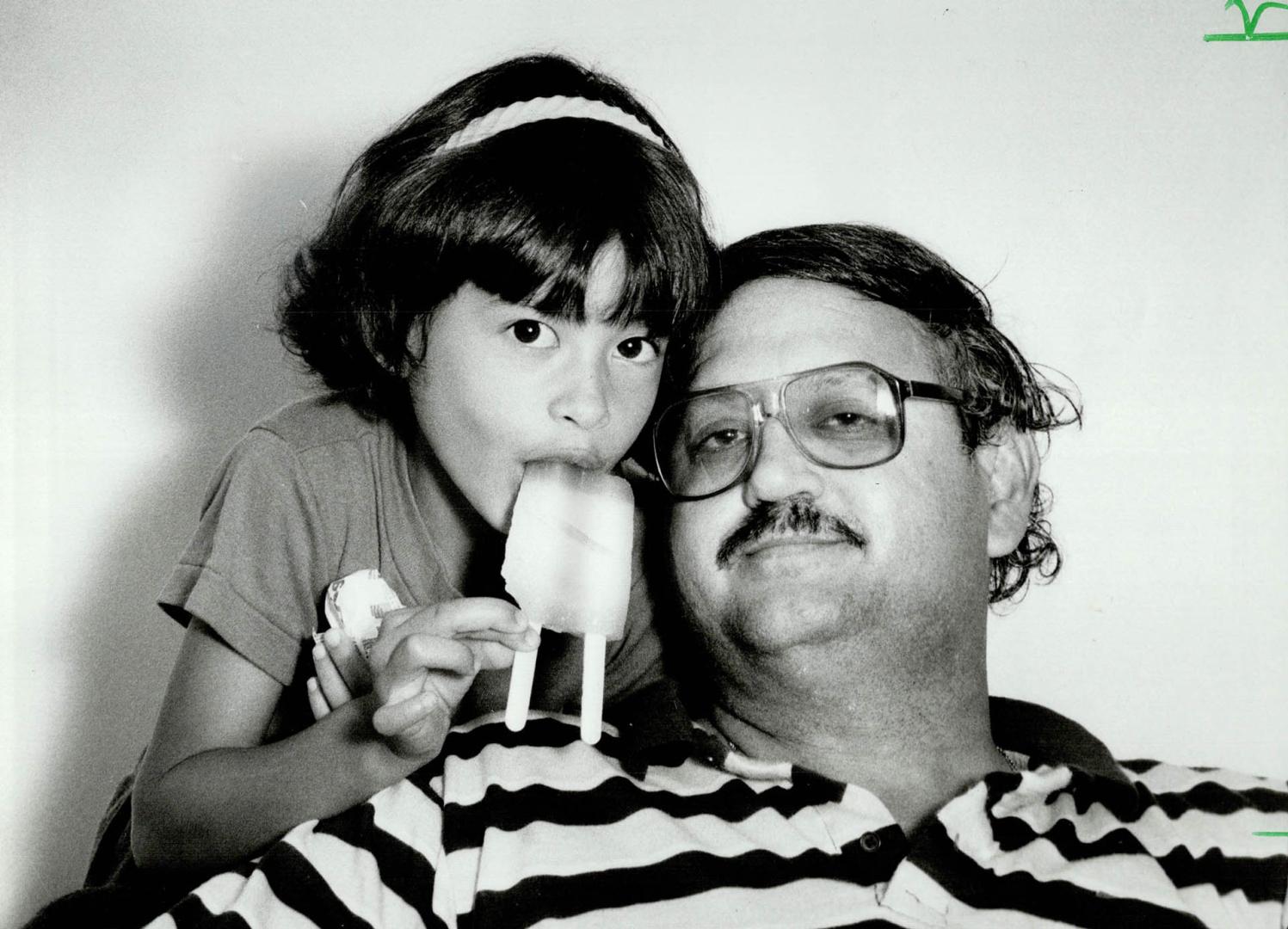 A real treat: While at the supermarket buying his daughter Tina, 7, a popsicle, Leslie Nascimento checked winning lottery numbers and found he had won $1 million
