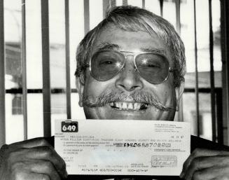 That's a $4 million smile, Michele Tullo, a 64-year-old Toronto janitorial contractor, shows off the cheque for $4,065,870 he picked up at the Ontario(...)
