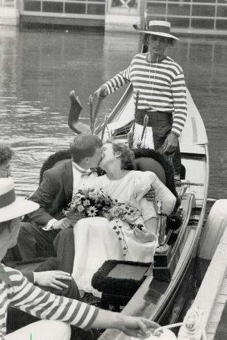 Tying the nautical knot, John and Patsy MacKenzie seal their wedding with a kiss yesterday after getting married on board an authentic Venetian gondol(...)