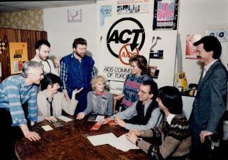 Members of the AIDS Committee of Toronto meet at their headquarters