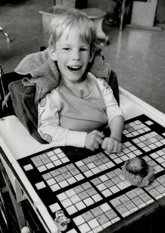Communicating is bliss: Andrew Spencer, 5, has learned to communicate for the first time through a Blissymbol board