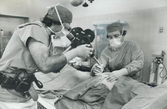 Cameraman Elias Petras and Dr. Philip Hall demonstrate technique of filming live fetus in womb