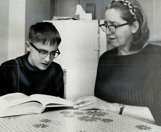 Mrs. Elsie Smetana and son Joey work at reading lesson, Joey who has mild cerebral palsy has not been allowed to attend regular classes